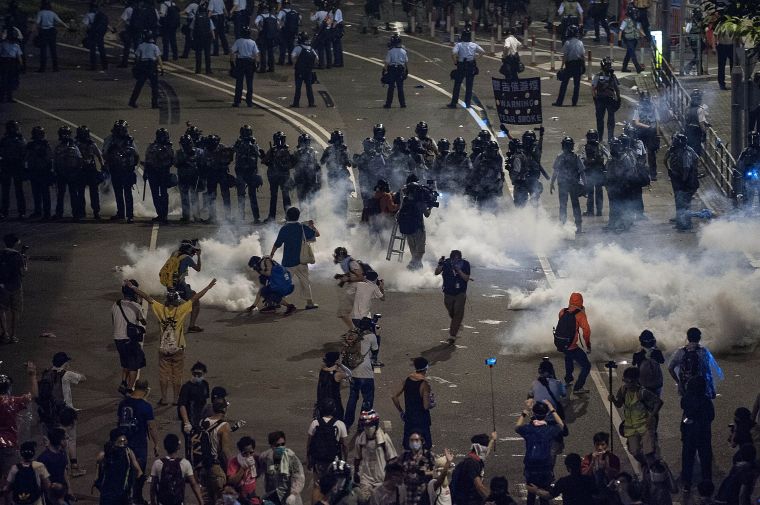 Police and demonstrators clash in the street during Hong Kong’s Umbrella Revolution, spurred by Chinese government’s plans to vet candidates in Hong Kong’s 2017 elections.