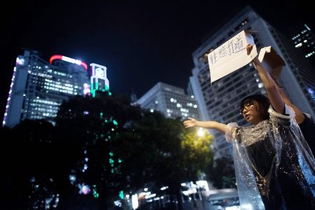 A man holds up a sign during Hong Kong’s Umbrella Revolution.