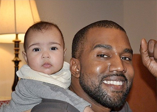 Kanye West playing with his daughter.