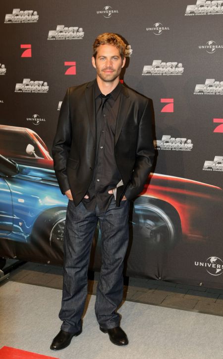 Paul sports a shiny sport coat, black button down, denim and his million dollar smile for the European premiere of “Fast & Furious.”
