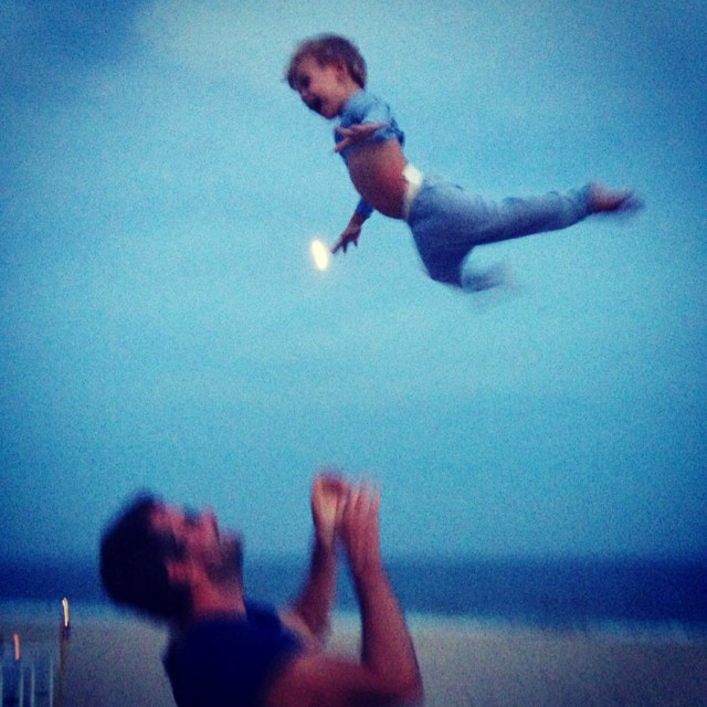 Daddy teaching son to fly while M snaps a pic.