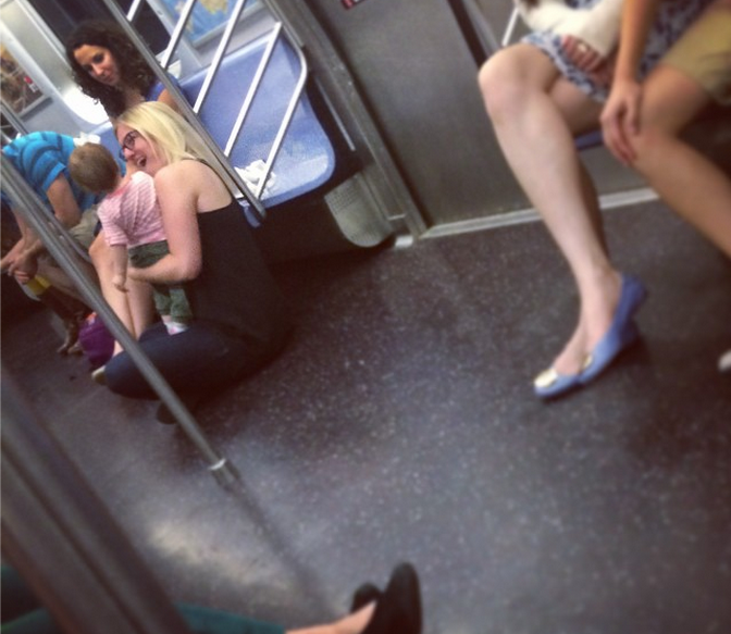 All Those Open Subway Seats & She Decides To Sit On The Floor.