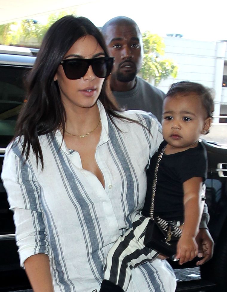 While in London, the little fashionista donned black and white striped pants and Doc Martens. Oh, and a YSL bag that may cost more than your rent.