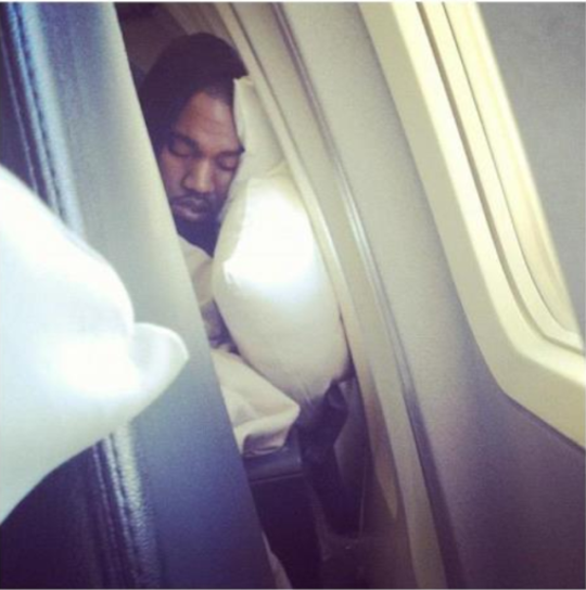 Kanye sleeping on the plane.