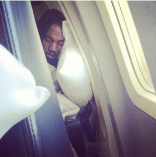 Kanye sleeping on the plane.