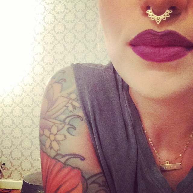 Bold tats and a bold lip.