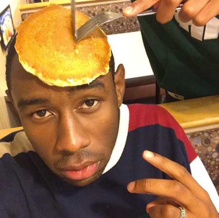 This is Tyler, The Creator with a pancake on his head.