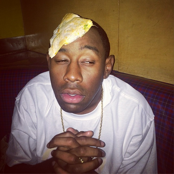 This is Tyler, The Creator with a quesadilla on his head.