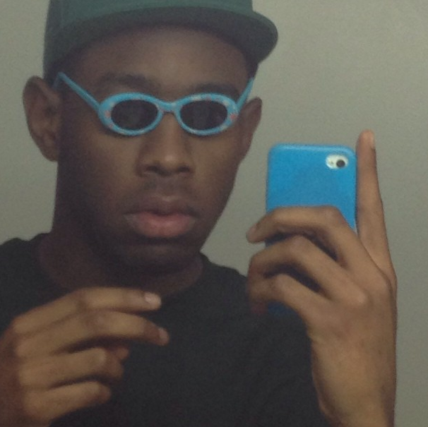 This is Tyler, The Creator wearing a ridiculously small pair of sunglasses.