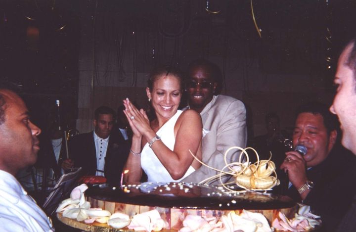Diddy wraps his arms around his girl as the surprise birthday bash fun begins.
