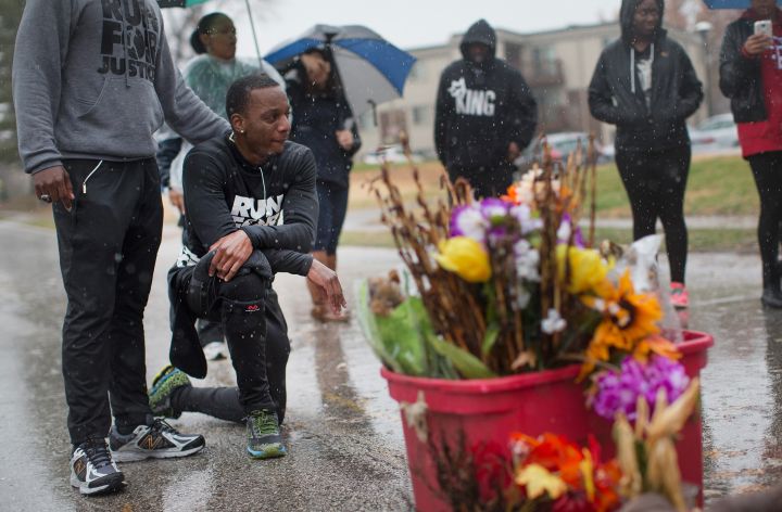 Mills consoles Hall as they arrive at Michael Brown’s Memorial In Ferguson.