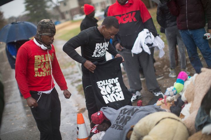 Londrelle Hall and Ray Mills pay their respects at the Michael Brown Memorial in Ferguson.