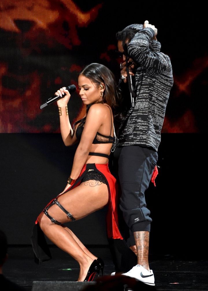 Dip It Low…Pick It Up Slow. Christina backs up on Weezy as the two perform at the 2014 American Music Awards.