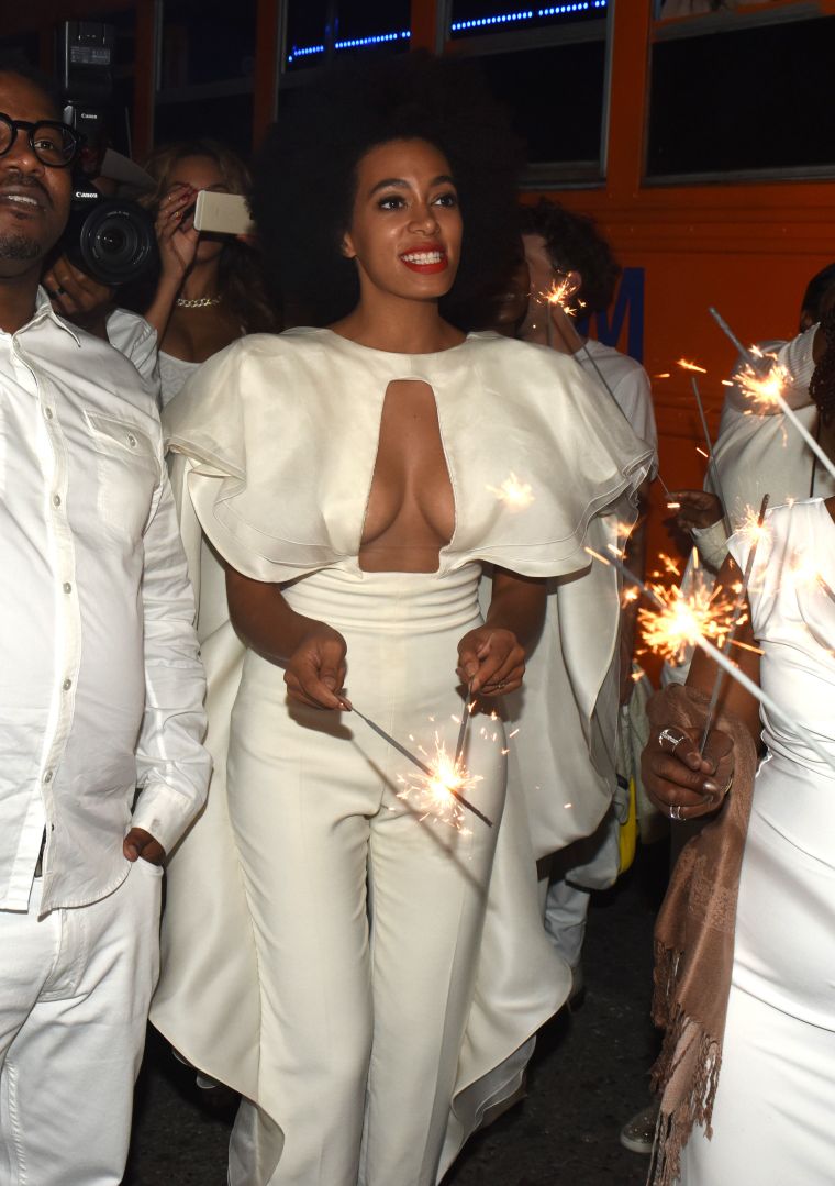 Solange outshines the sparklers in her all-white jumpsuit.