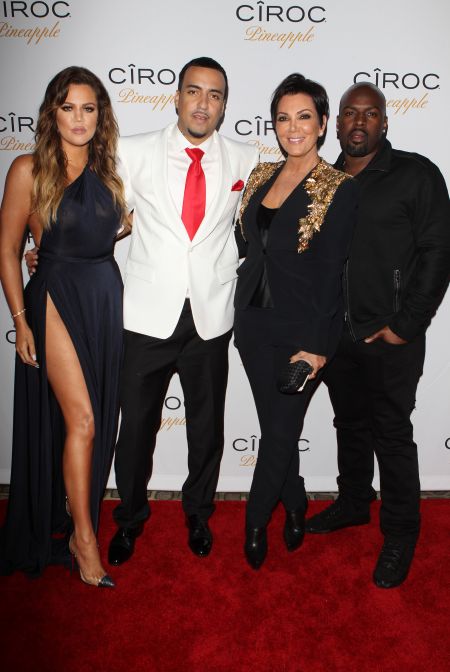 Khloe, French, Kris, and her boo pose together on the carpet.