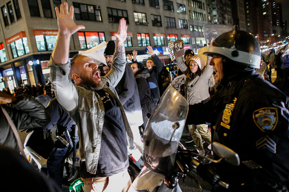 A man yells at police as he takes part in a protest after a grand jury decided not to indict New York Police Officer Daniel Pantaleo in the death of Eric Garner.