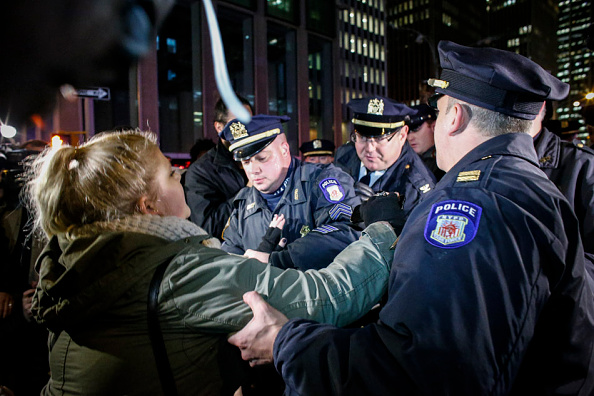 A woman is arrested by police as she takes part in a protest after a grand jury decided not to indict New York Police Officer Daniel Pantaleo in the death of Eric Garner.