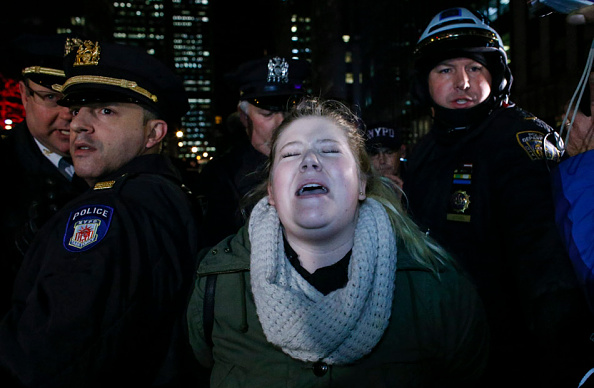 A woman is arrested by police as she takes part in protest after a grand jury decided not to indict New York Police Officer Daniel Pantaleo in the death of Eric Garner.