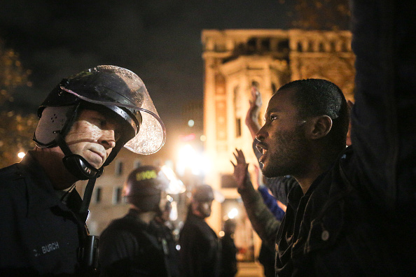 A man yells at a police officer during a protest in Oakland, Ca.