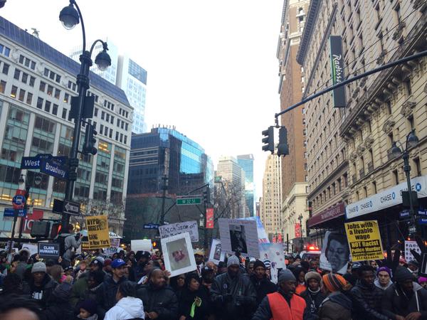 Protestors march up 5th Avenue.