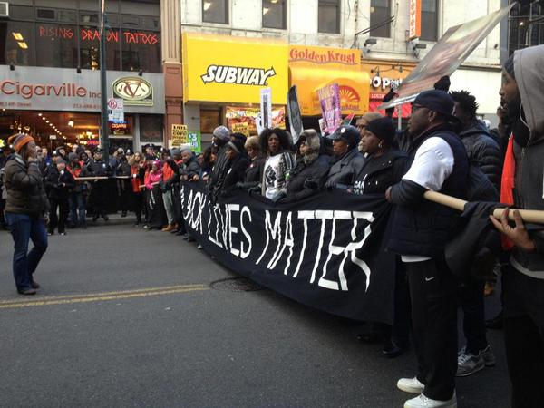 Protestors lead by holding up a ‘Black Lives Matter’ banner.