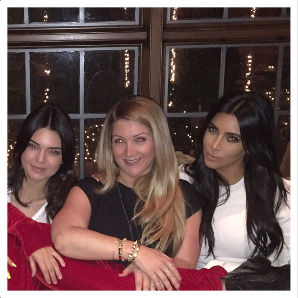 Kim and Kendall lean in for a photo with a friend.