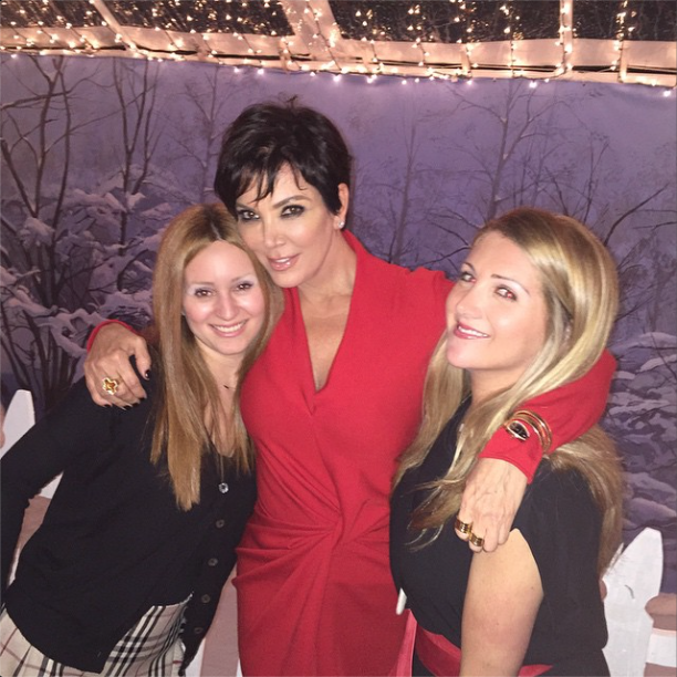 Kris Jenner poses with friends at a Christmas party.