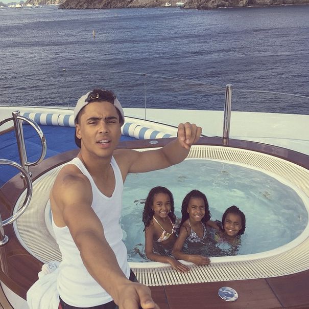 Quincy Combs hangs by the jacuzzi with the girls.