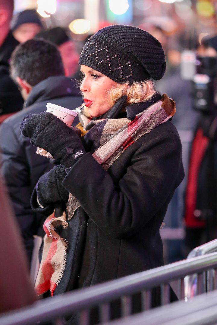 Jenny McCarthy sips her hot coffee through a straw while rehearsing for New Year’s Eve with Ryan Seacrest in Times Square, New York City.