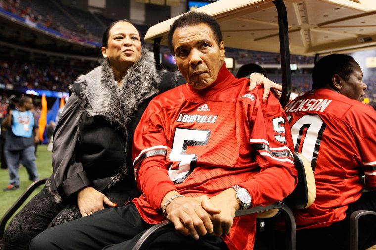 Boxing legend Muhammad Ali rides a golf cart onto the field to represent the Louisville Cardinals for the coin toss against the Florida Gators prior to the start of the Allstate Sugar Bowl at Mercedes-Benz Superdome.