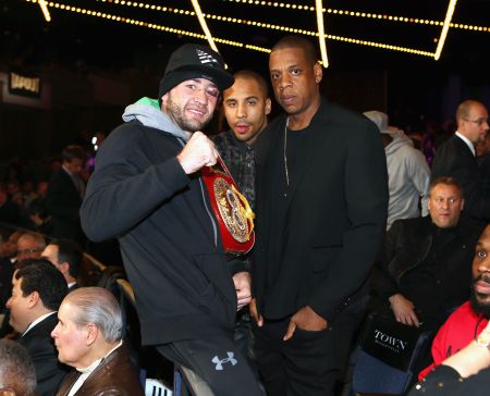 Jay Z poses with Andre Ward and a guest.