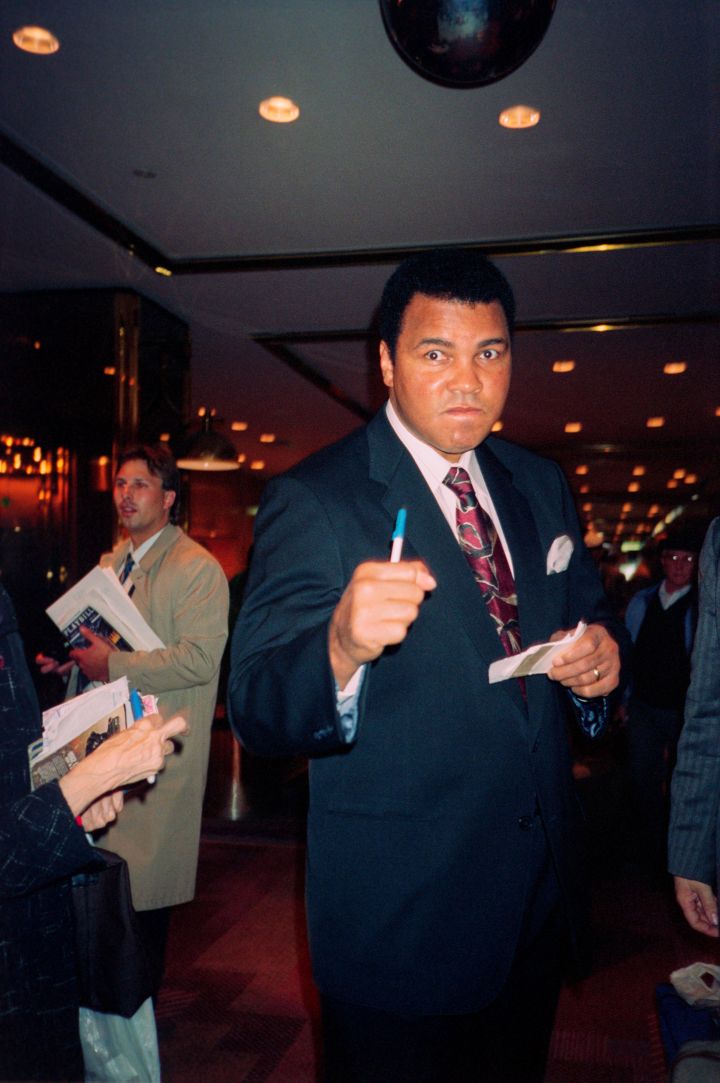 Muhammad Ali signing autographs in the NY Hilton Hotel; circa 1990; New York.