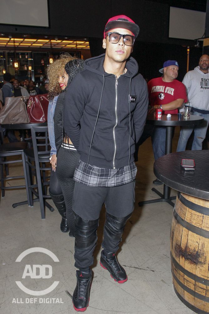 Quincy was decked in all-black everything with some red accents.