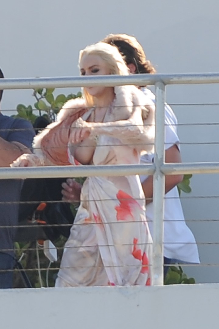 Lindsay Lohan had a major wardrobe malfunction as her breast popped out of her dress as she took to the rooftop of the Raleigh Hotel for a Plum magazine shoot.