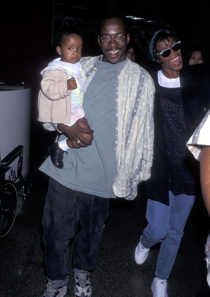 Bobby Brown, singer Whitney Houston, and daughter Bobbi Kristina Brown arrive from New York City on June 18, 1995.