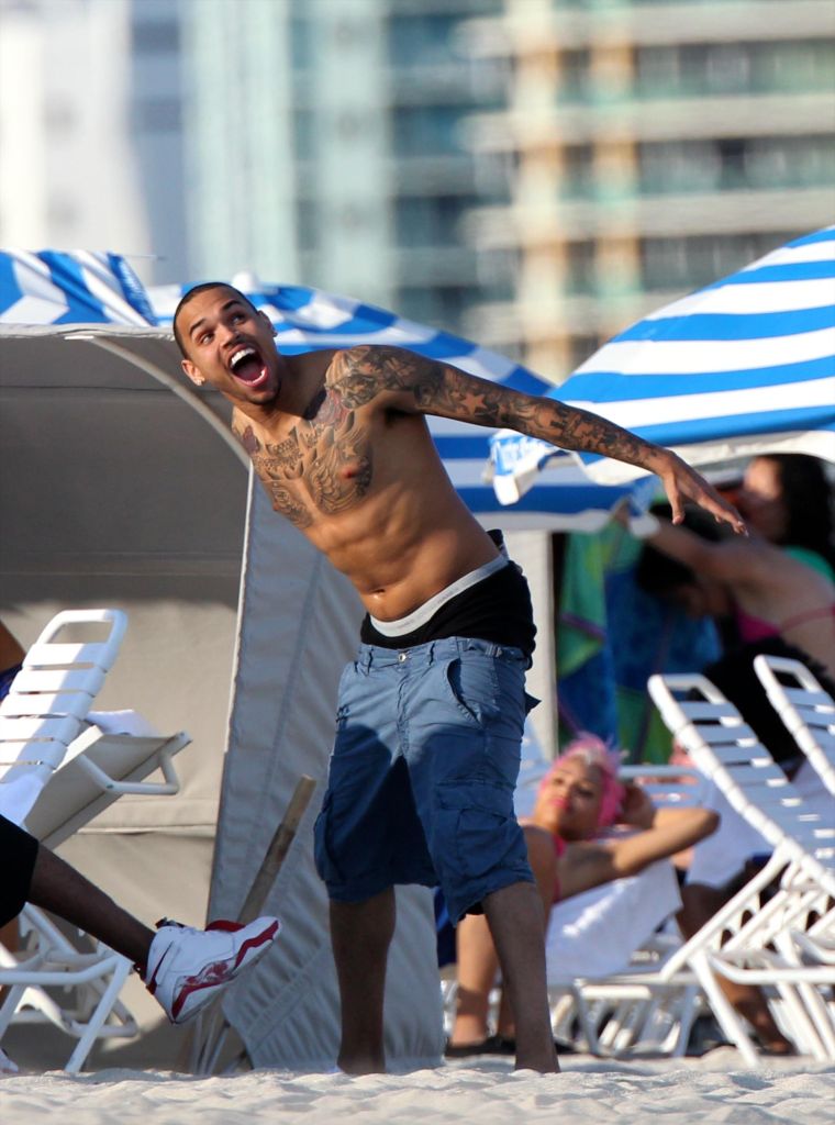 Chris Brown shirtless and showing off his tattoos.