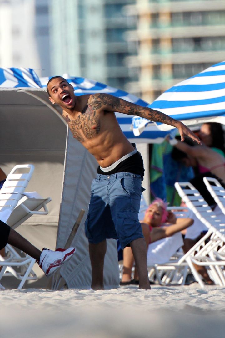 Chris Brown shirtless and showing off his tattoos.