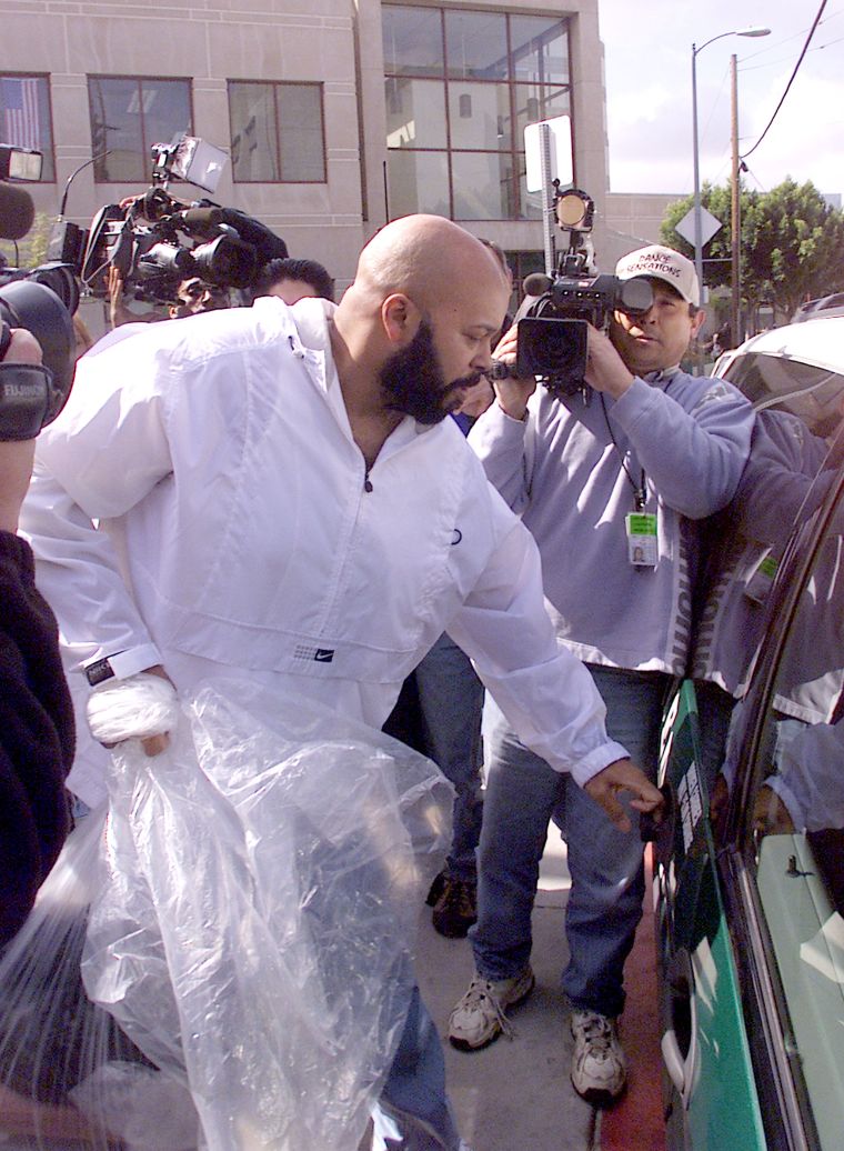 The Death Row founder is seen minding his own business amidst a sea of photographers.