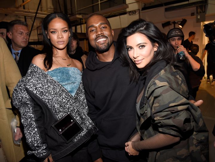 Kanye actually smiled while posing for some photos with Rihanna and Kim.