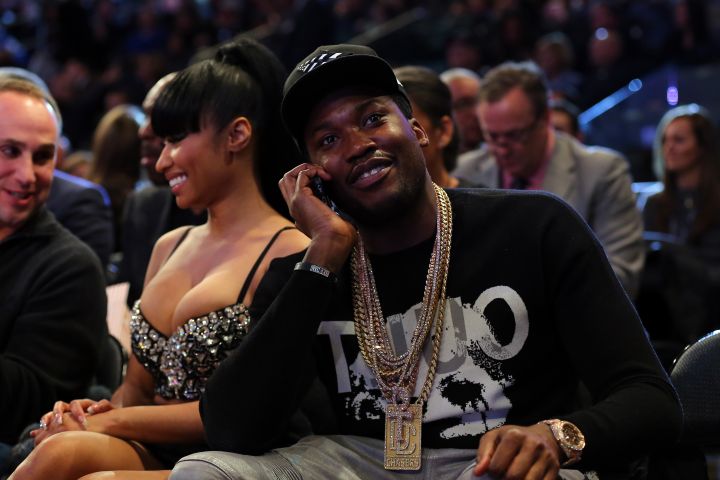 Nicki and Meek cuddle up courtside at the game.