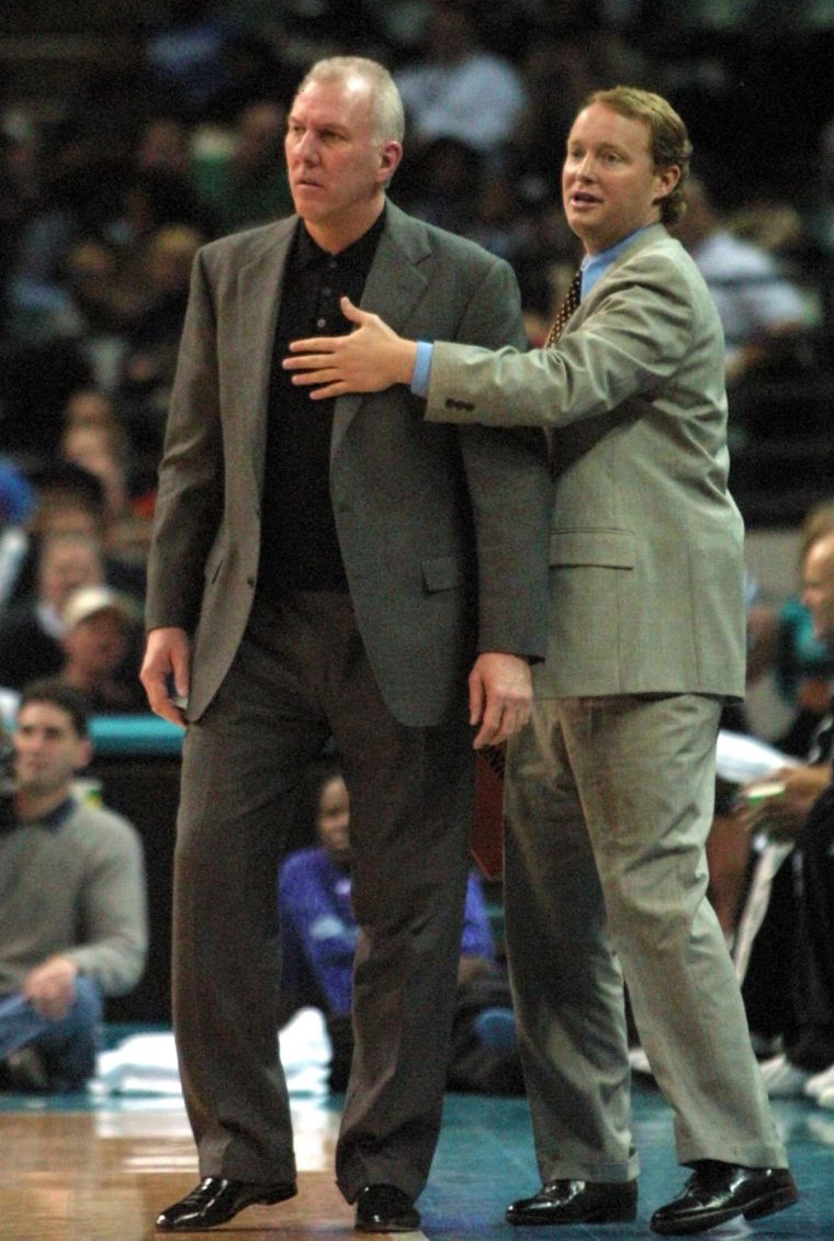 San Antonio Spurs legend Gregg Popovich being restrained by this year’s Eastern Conference All-Star team coach Mike Budenholzer after Pop received a technical foul, 2000.