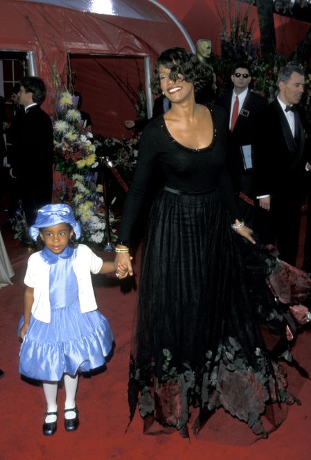 Daughter Bobbi walks the carpet with her mother Whitney Houston in March of 1999.