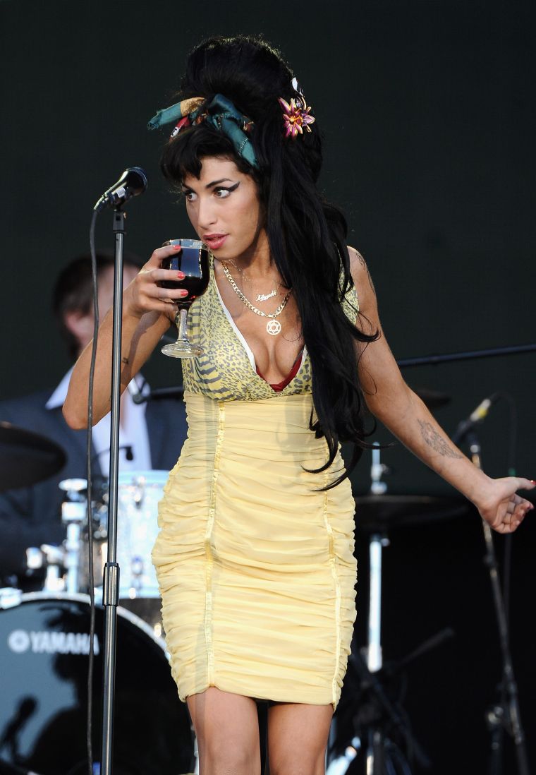 Amy Winehouse took a sip on stage.