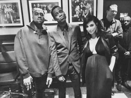 KimYe poses with Chris Rock backstage.