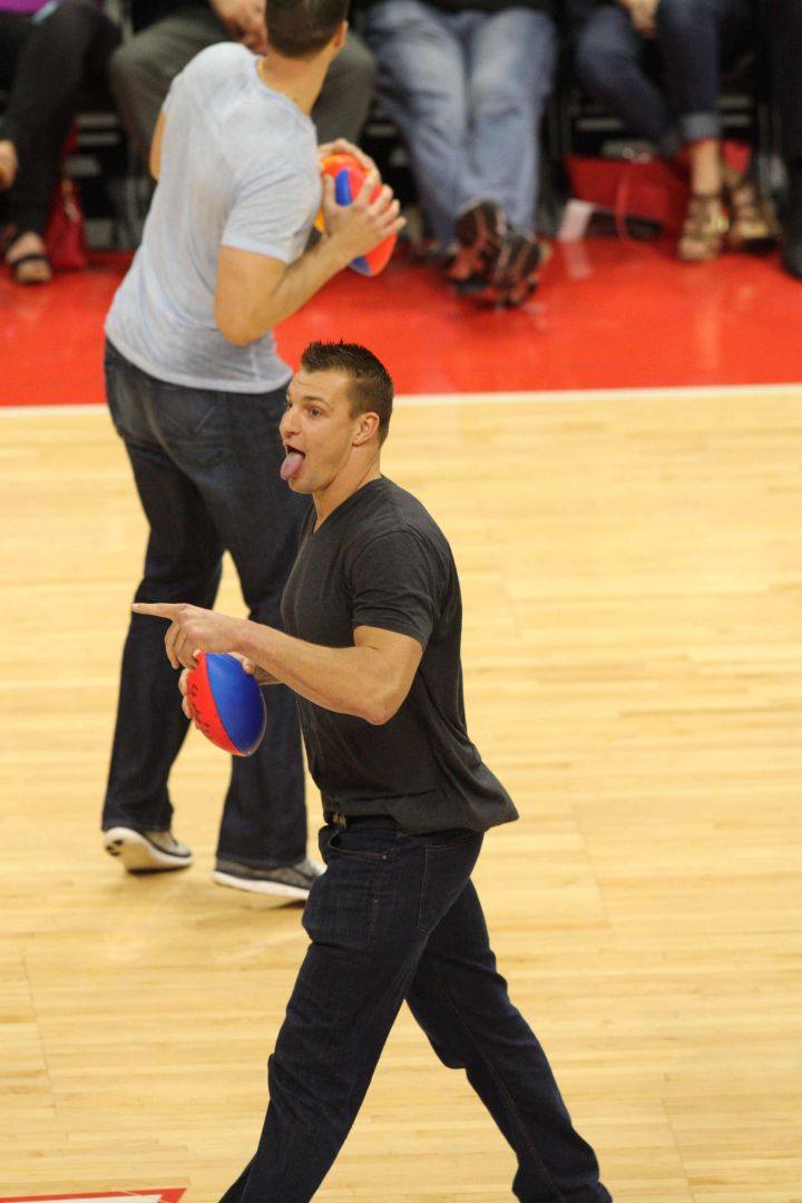 Rob Gronkowski of the New England Patriots throws footballs into the crowd at the L.A. Clippers game on Monday.