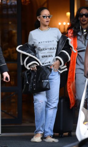 Rihanna seen leaving her hotel in Paris wearing fluffy shoes and grills on her teeth.