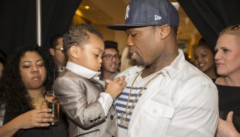 50 cent and Daphne Joy cheer on their son during LA Fashion Week