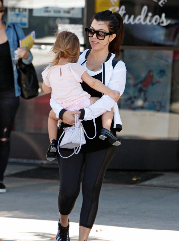 Kourtney often gets put on purse duty.