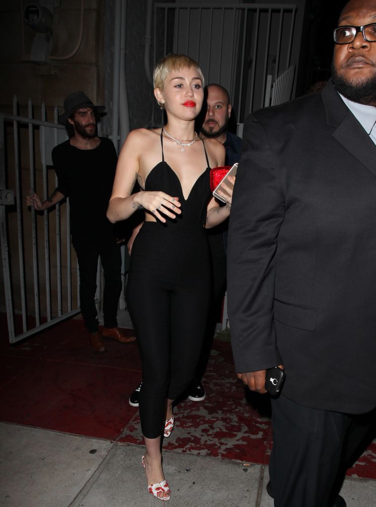 Miley Cyrus rocks a cleavage-baring romper with a red lip in West Hollywood.