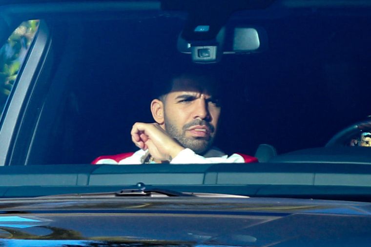 Drake falls victim to the California sun while leaving Cecconi's in West Hollywood.